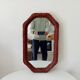 Vintage octagonal mirror in woven rattan.
