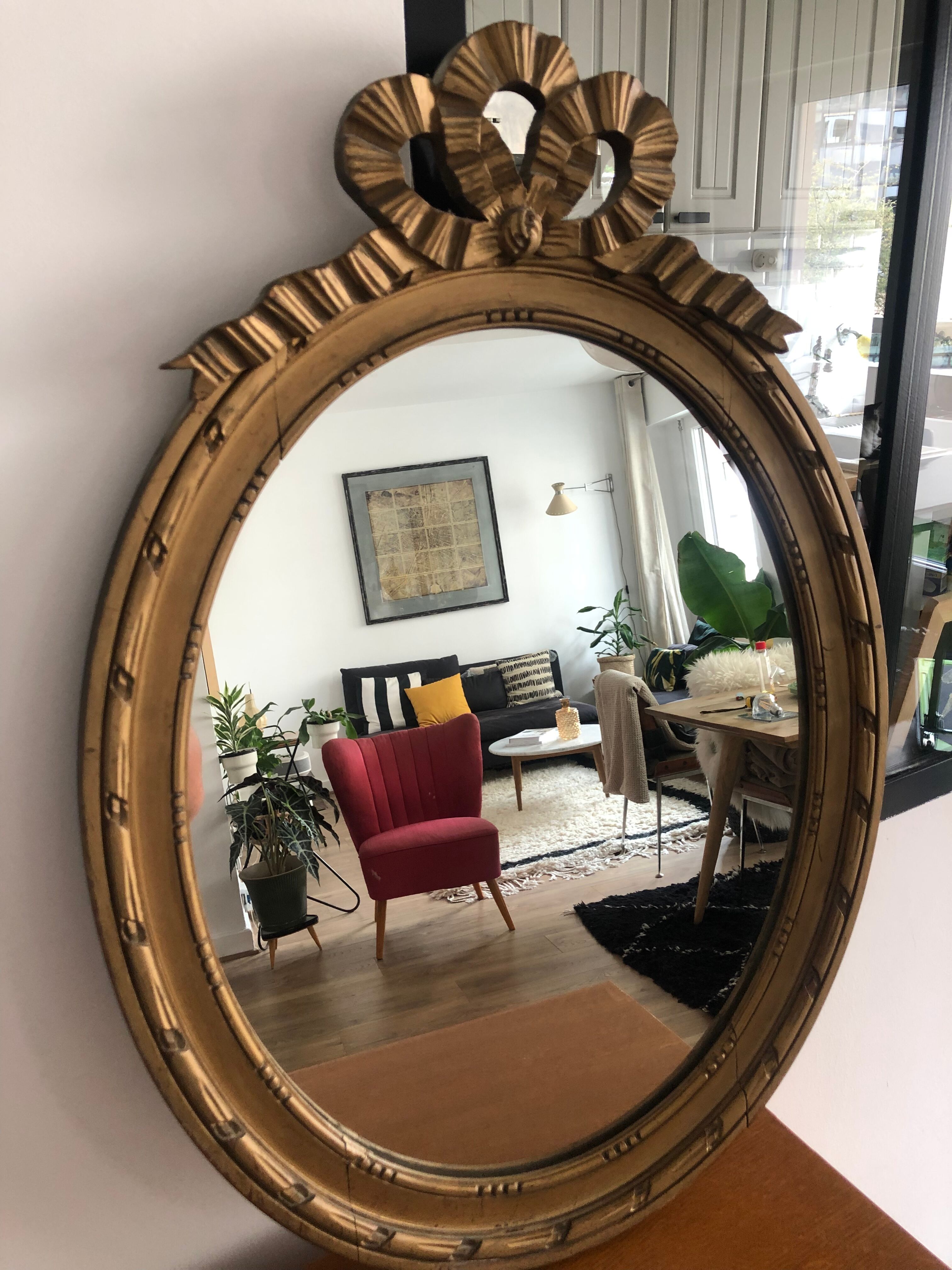 Old oval mirror with a pediment