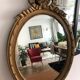 Old oval mirror with a pediment