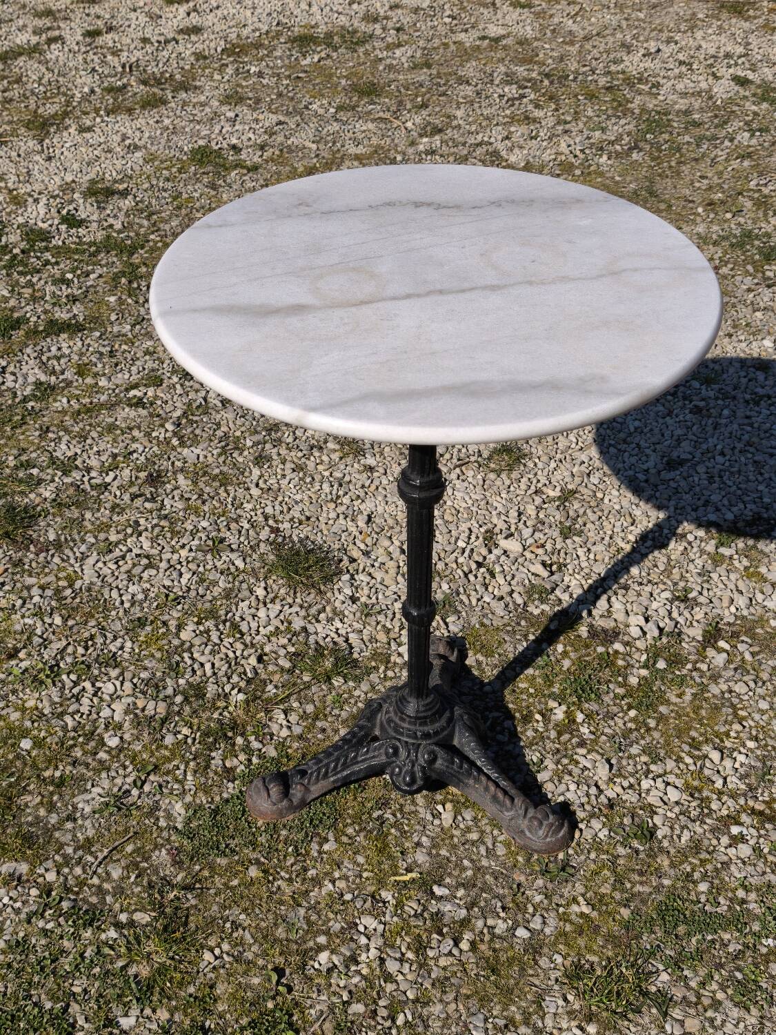 Marble bistro table with cast iron legs in Parisian café style
