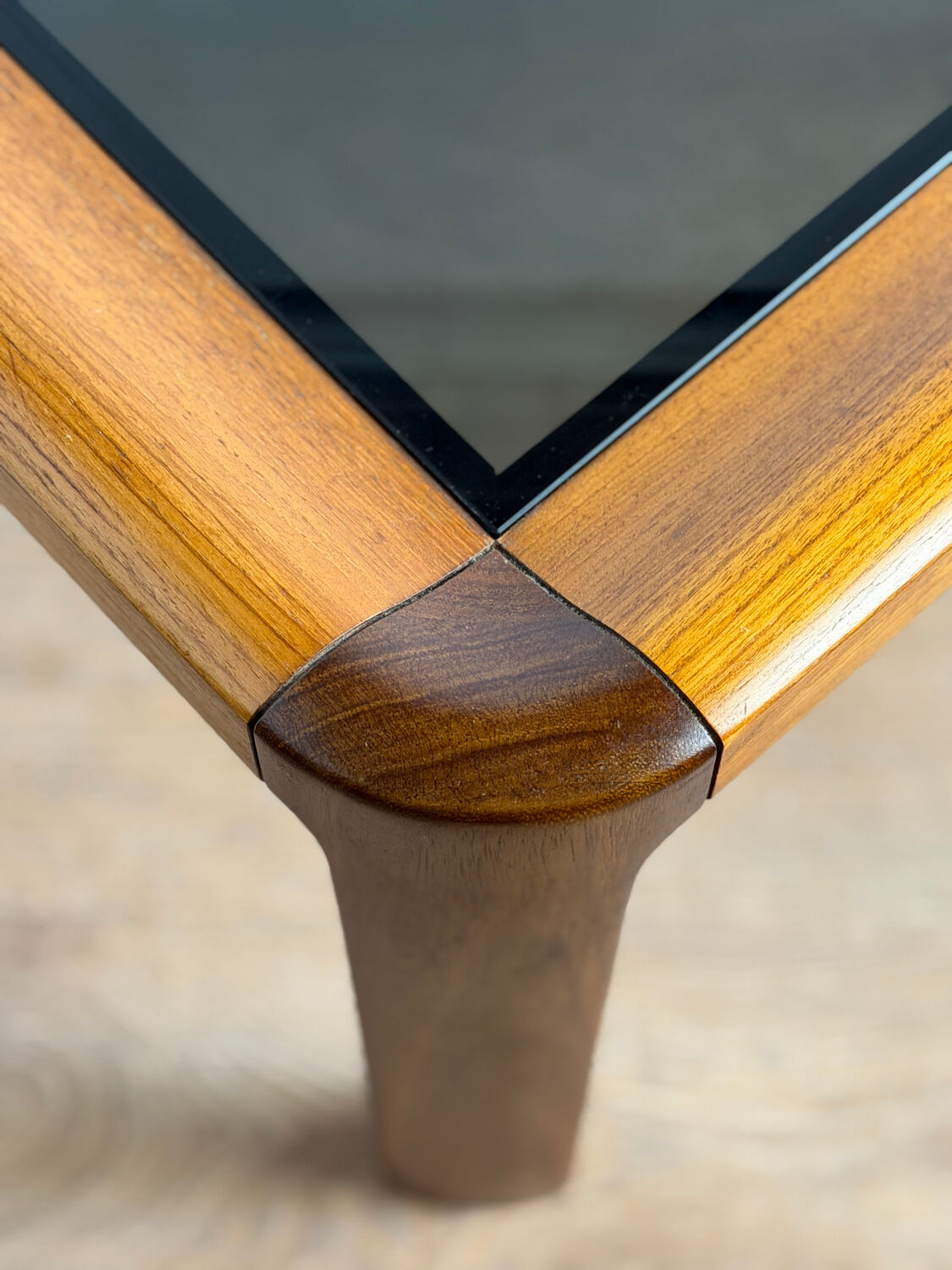Square wooden coffee table with glass.