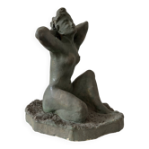 Sculpture of a naked woman titled "Youth" in terracotta.