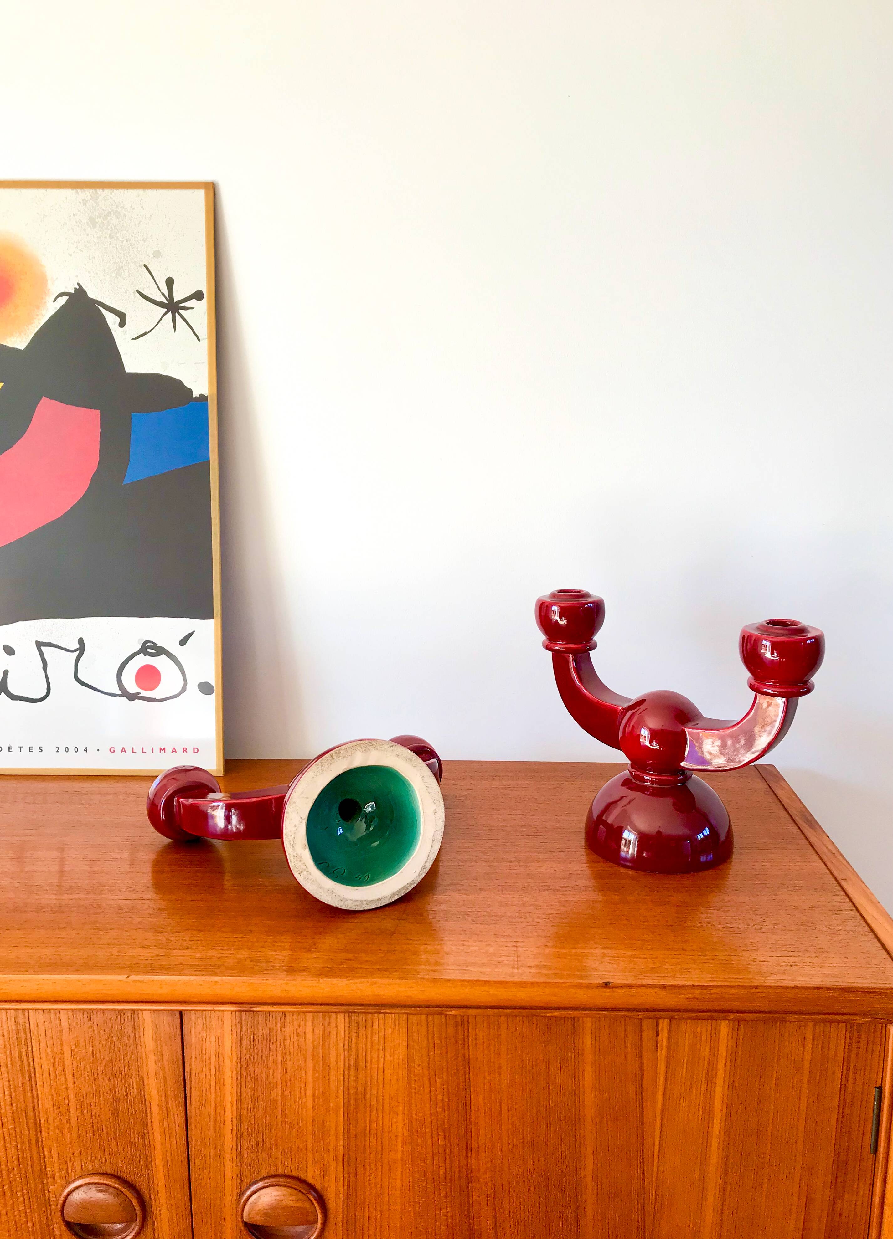 pair of burgundy enameled ceramic candlesticks / candelabras signed 1949