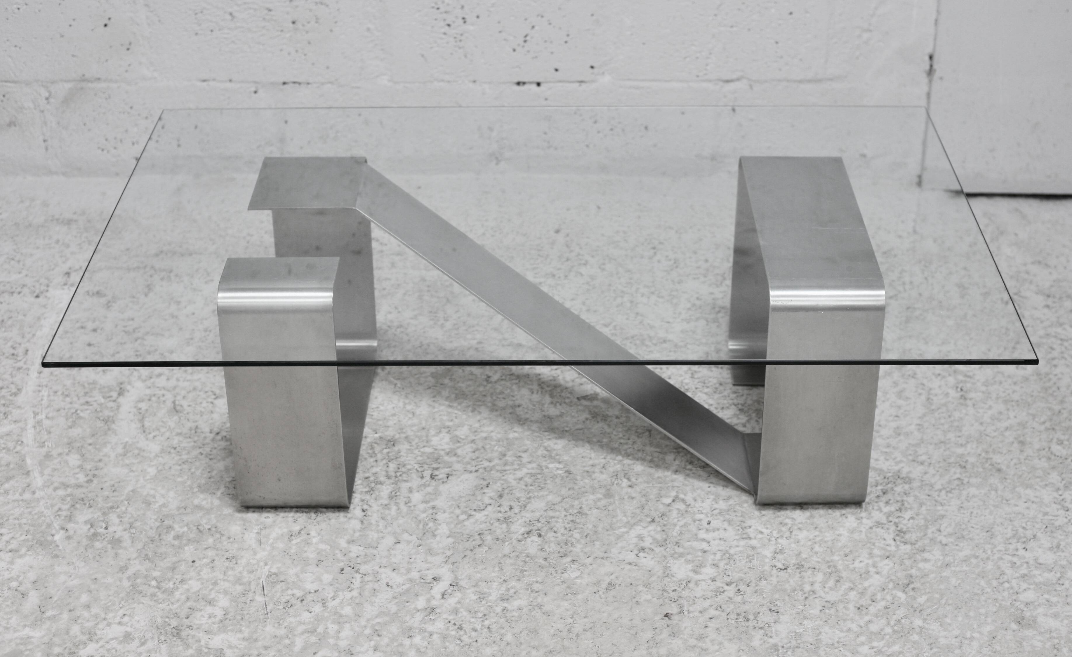 Coffee table with "kinetic" steel base and glass slab. Circa 1970.