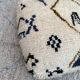 Berber floor pouf: Handwoven Moroccan wool cushion.