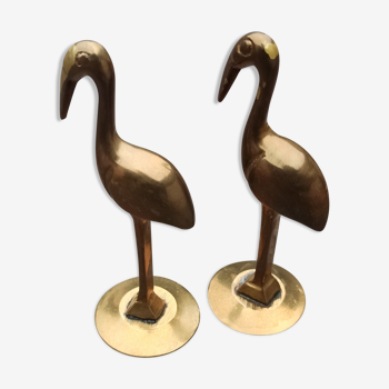 Two pink flamingos in old brass