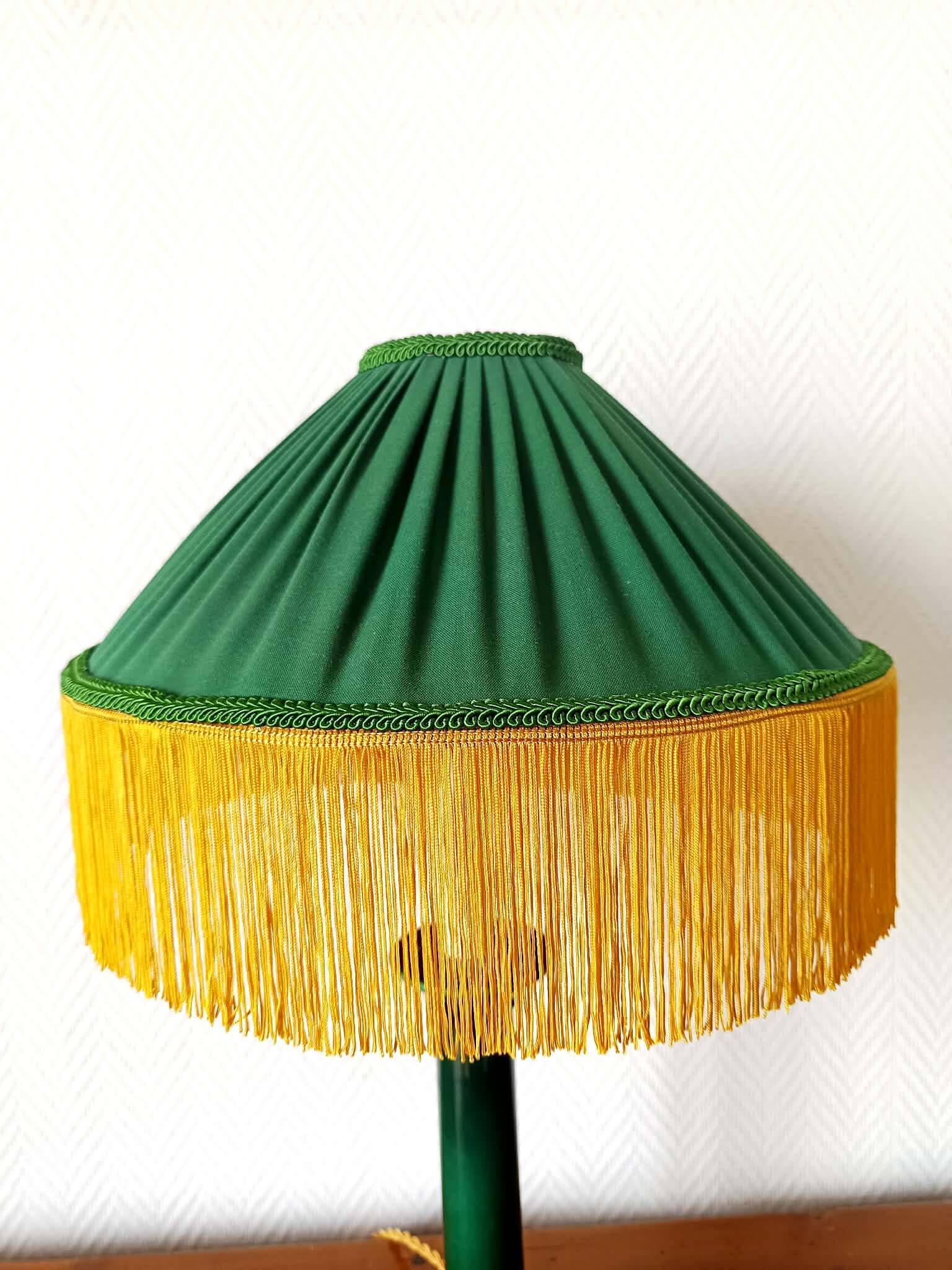 Green ceramic lamp with a vintage pleated fringe shade.