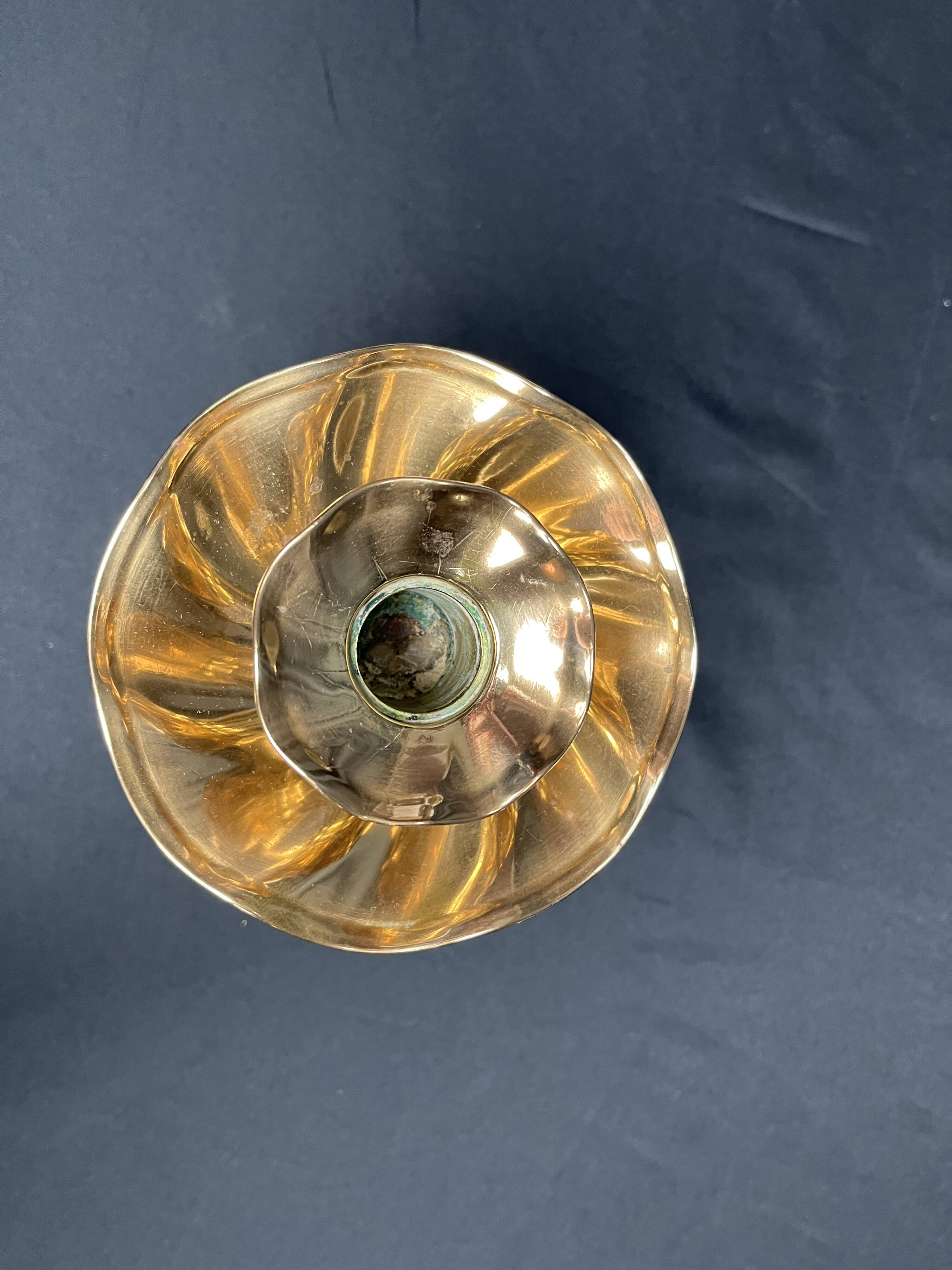 Brass candlestick in a fluted shape from the early 20th century.