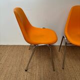 Two orange plastic pollak chairs at Orly airport