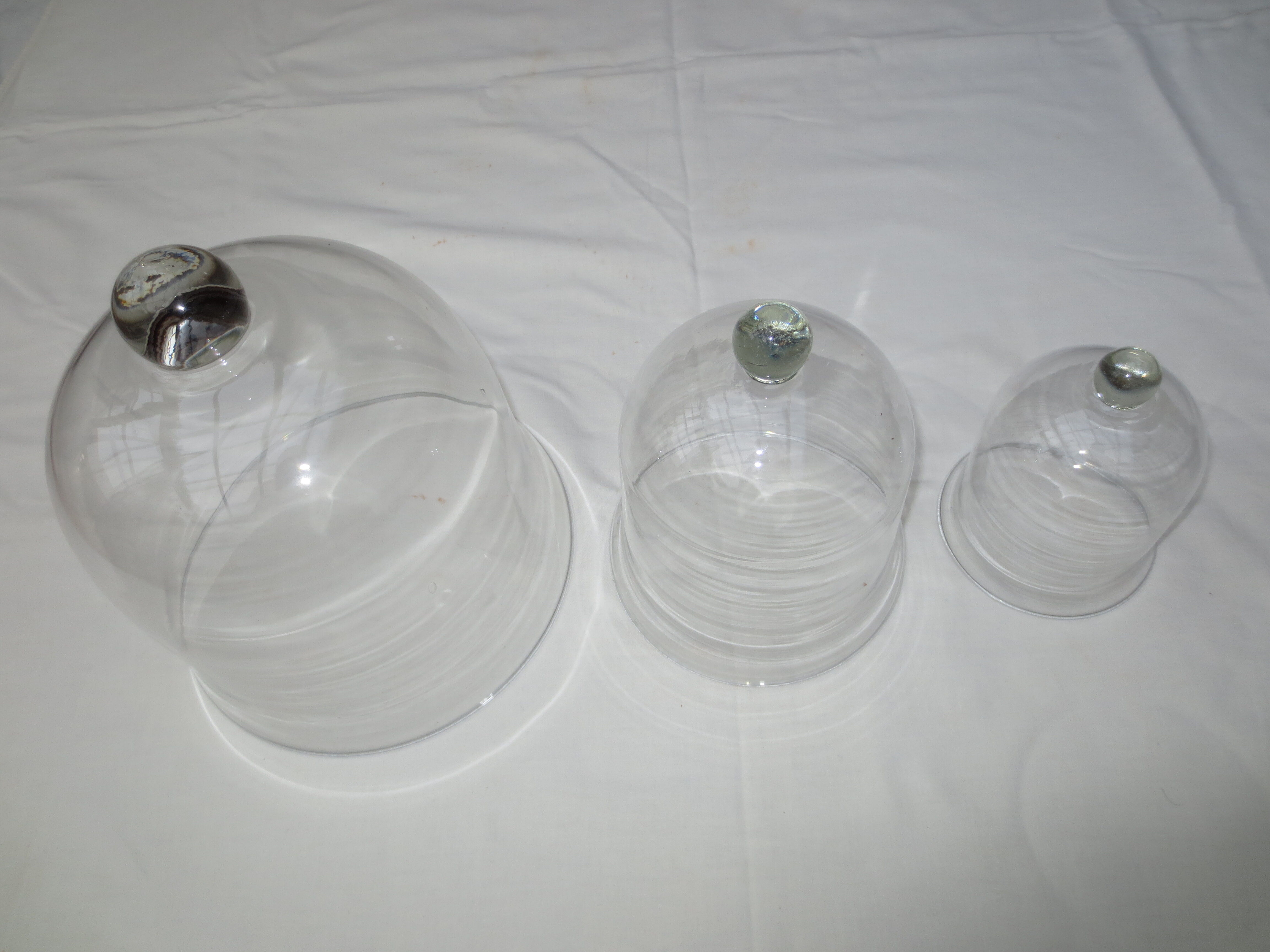 trio of old bells in transparent glass