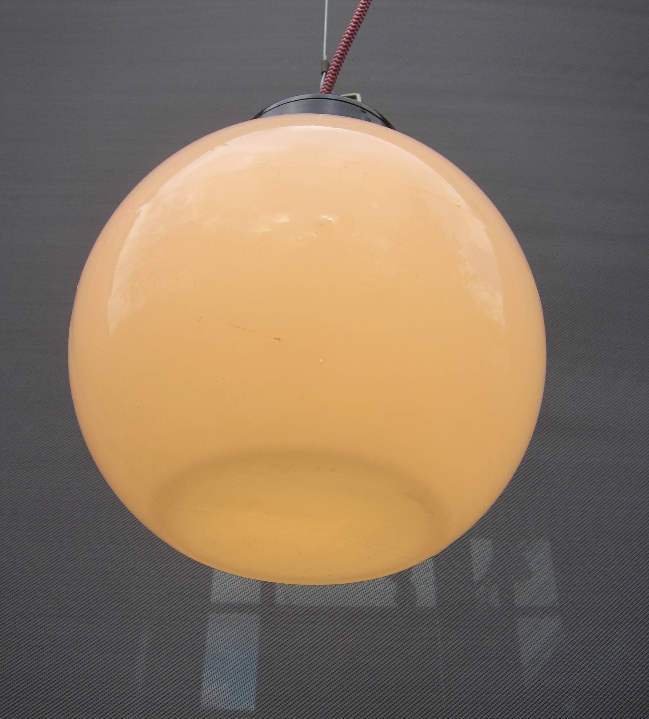 Trio of opal glass and bakelite globe pendant lights