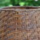 Large wooden lamp with a woven rattan shade.
