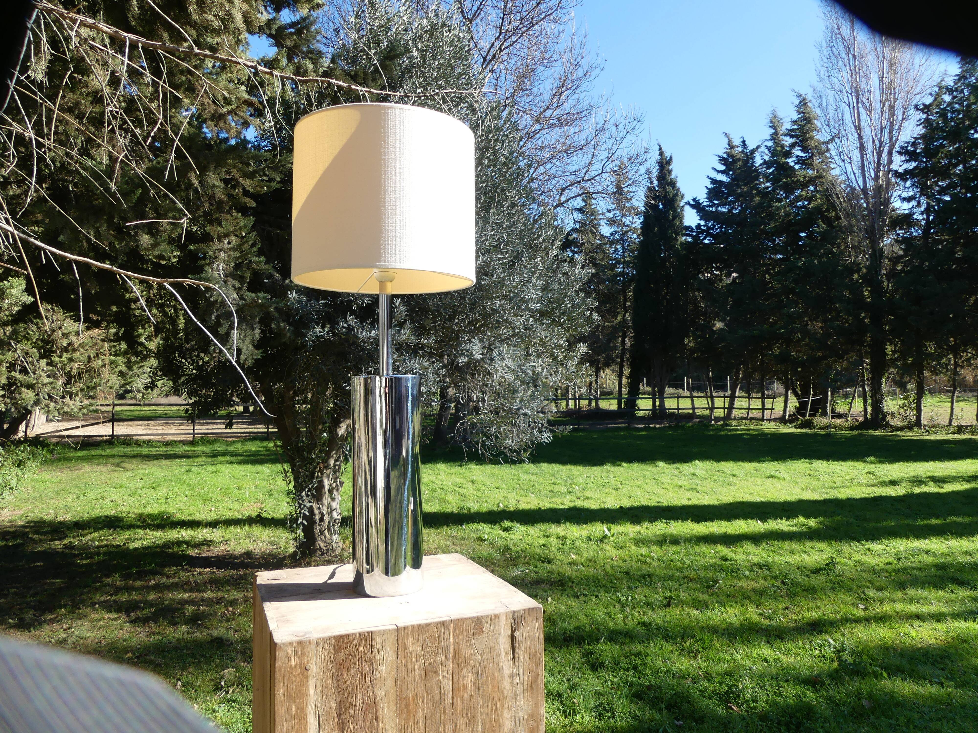 Foot of chrome lamps and ivory white lampshade