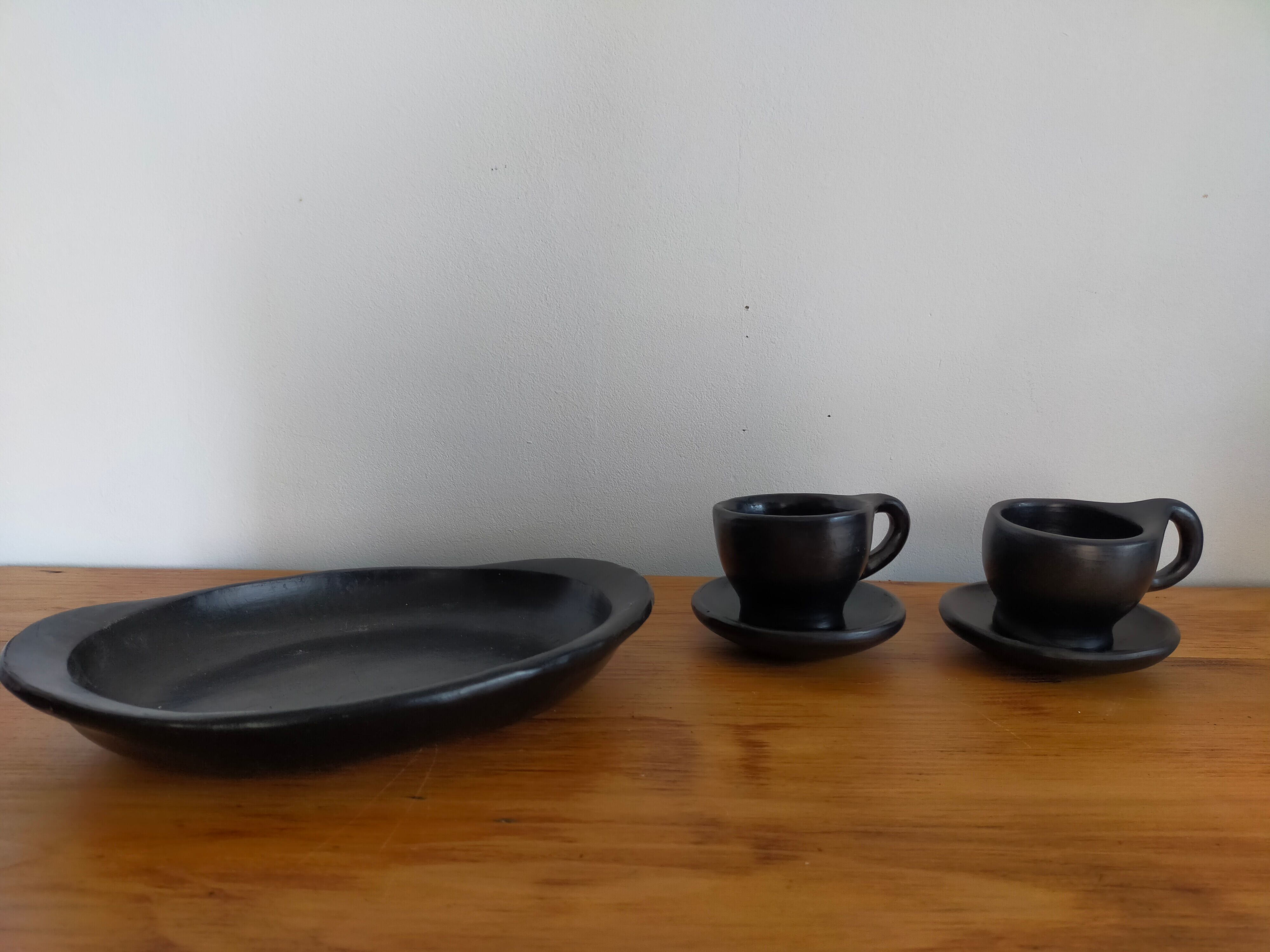 Terracotta service painted in black saucer cups and top