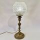 Antique brass foot lamp with glass globe and diamond point.