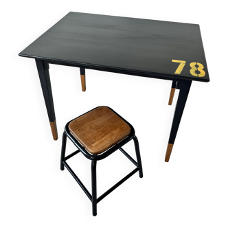 Office table and its low industrial stool.