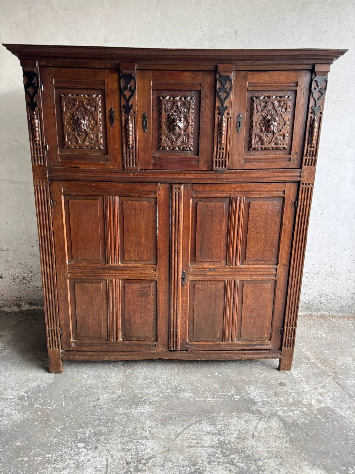 Antique Dark Wood Carved Cabinet with Hand-Carved Floral Motifs and Metal Handles