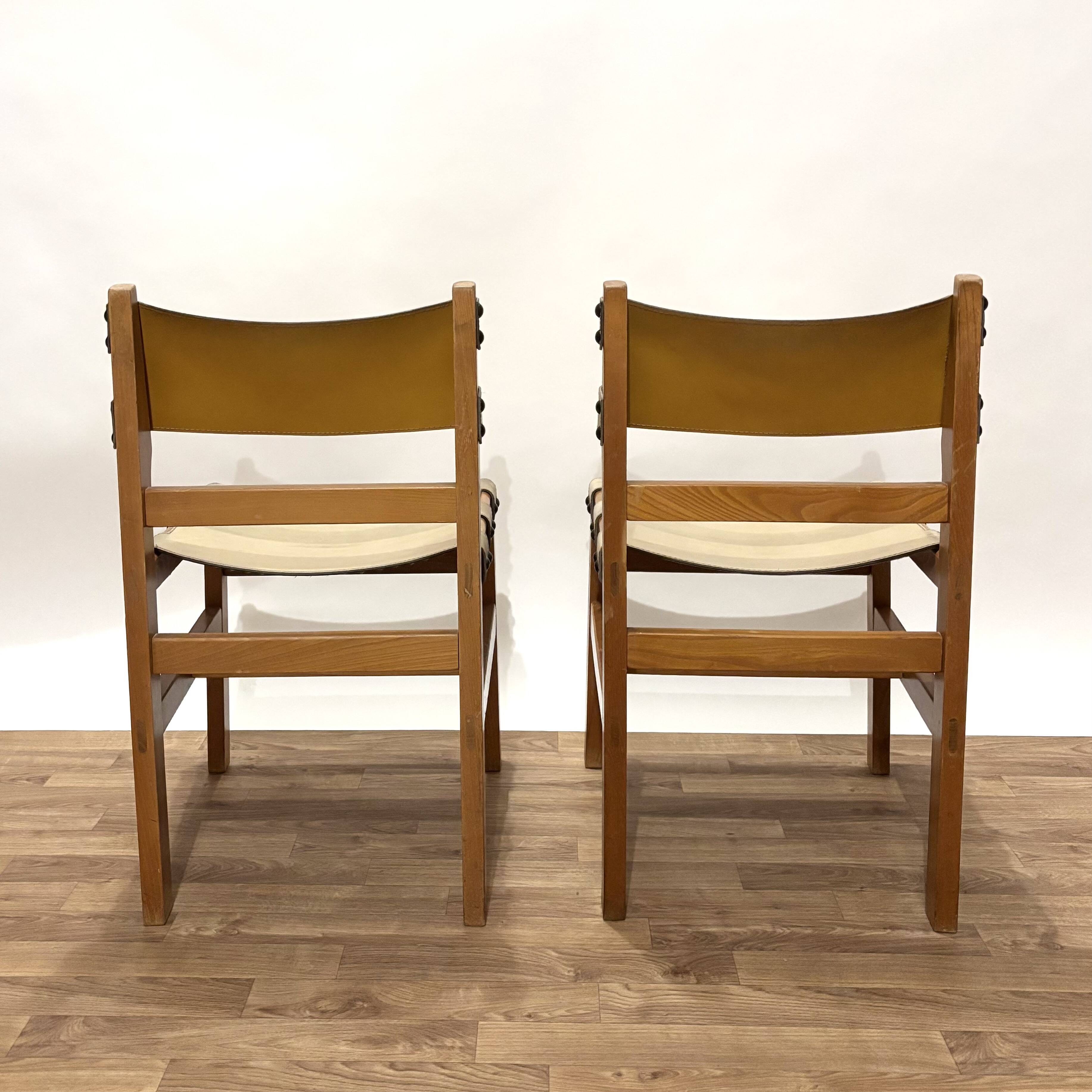 Pair of Maison Regain leather chairs