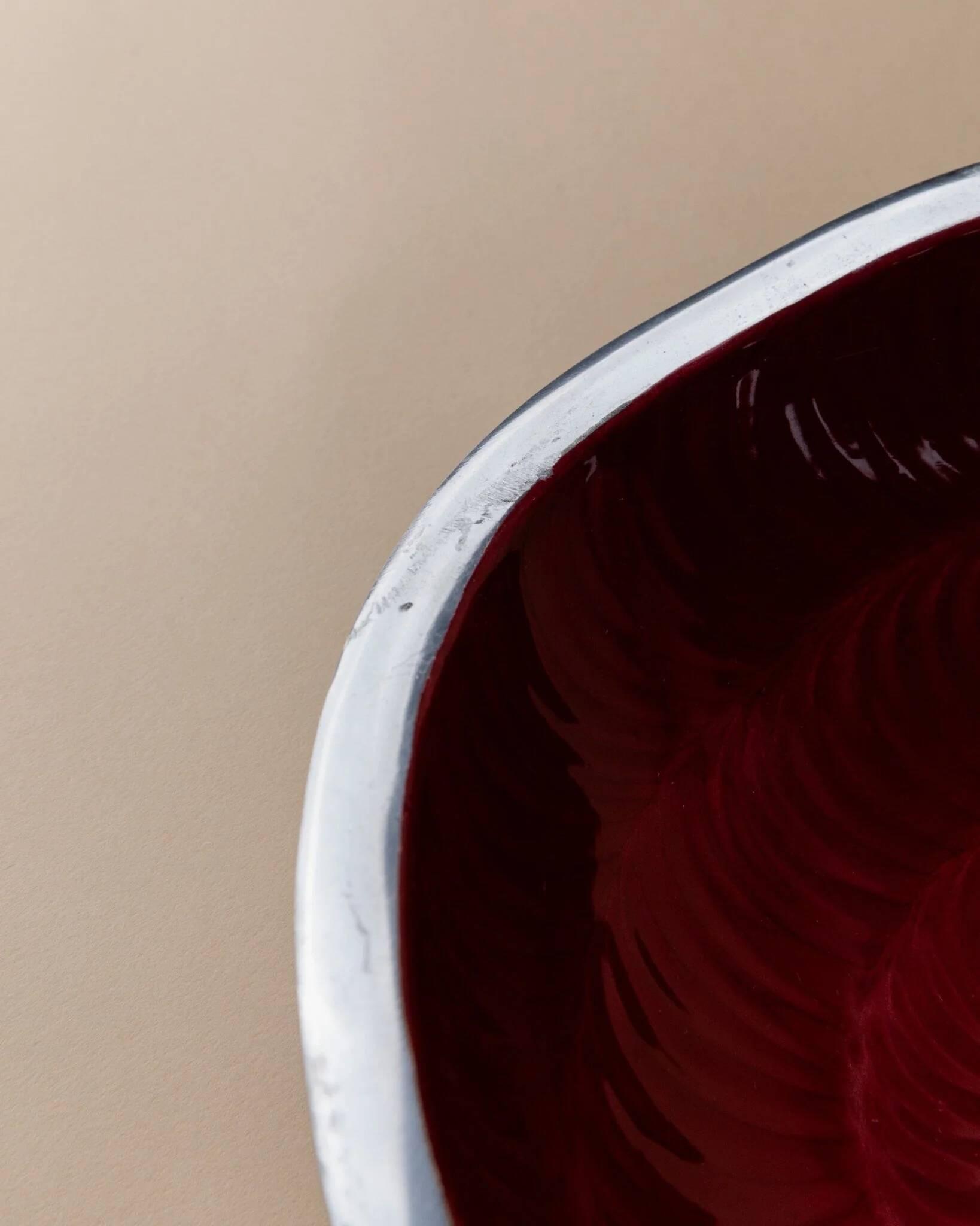 Red enameled steel bowl with textured interior and silver exterior; vintage Italian 1970s design