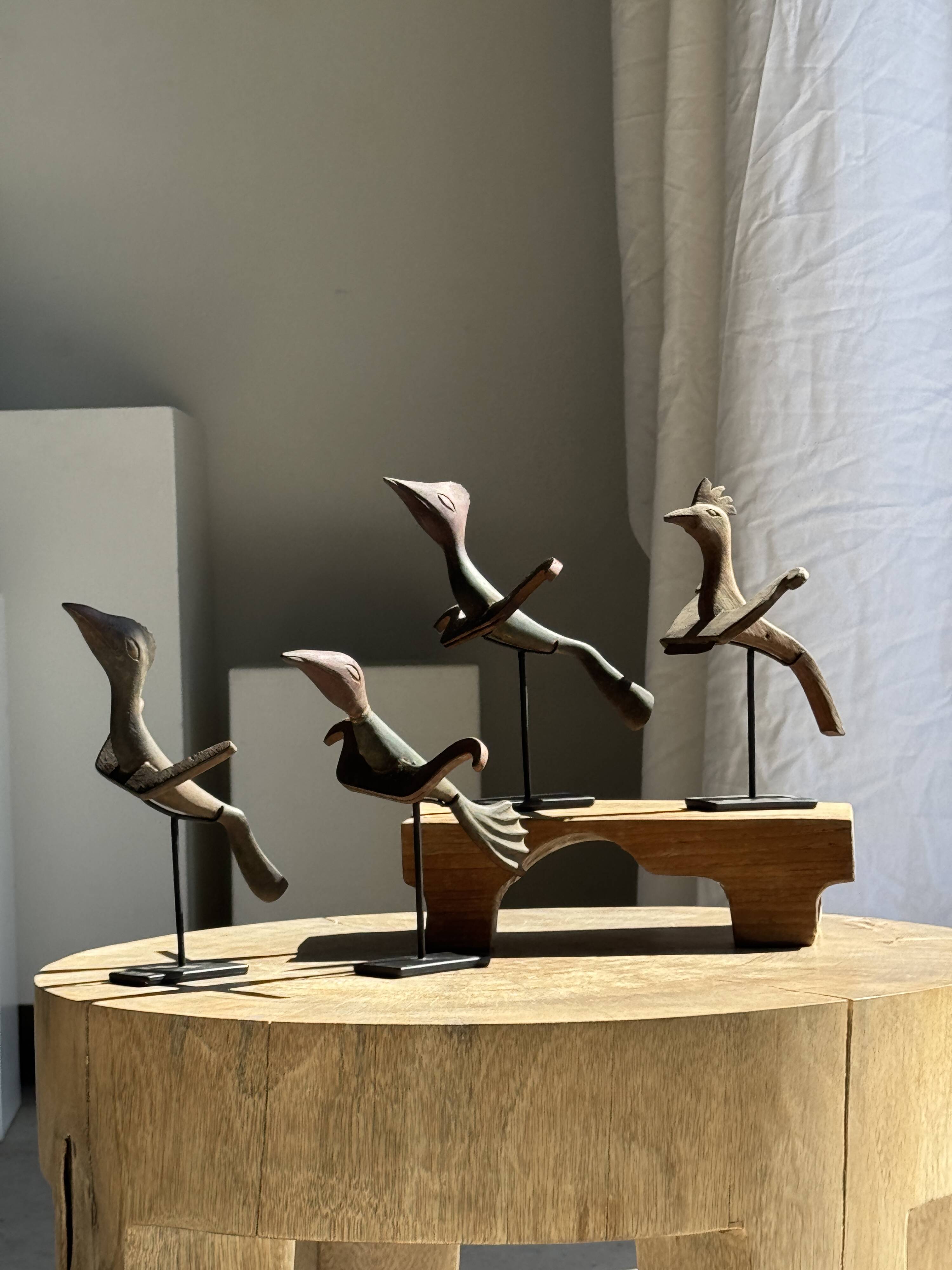 Traditional Indonesian decorative wooden bird on a base, crest model.
