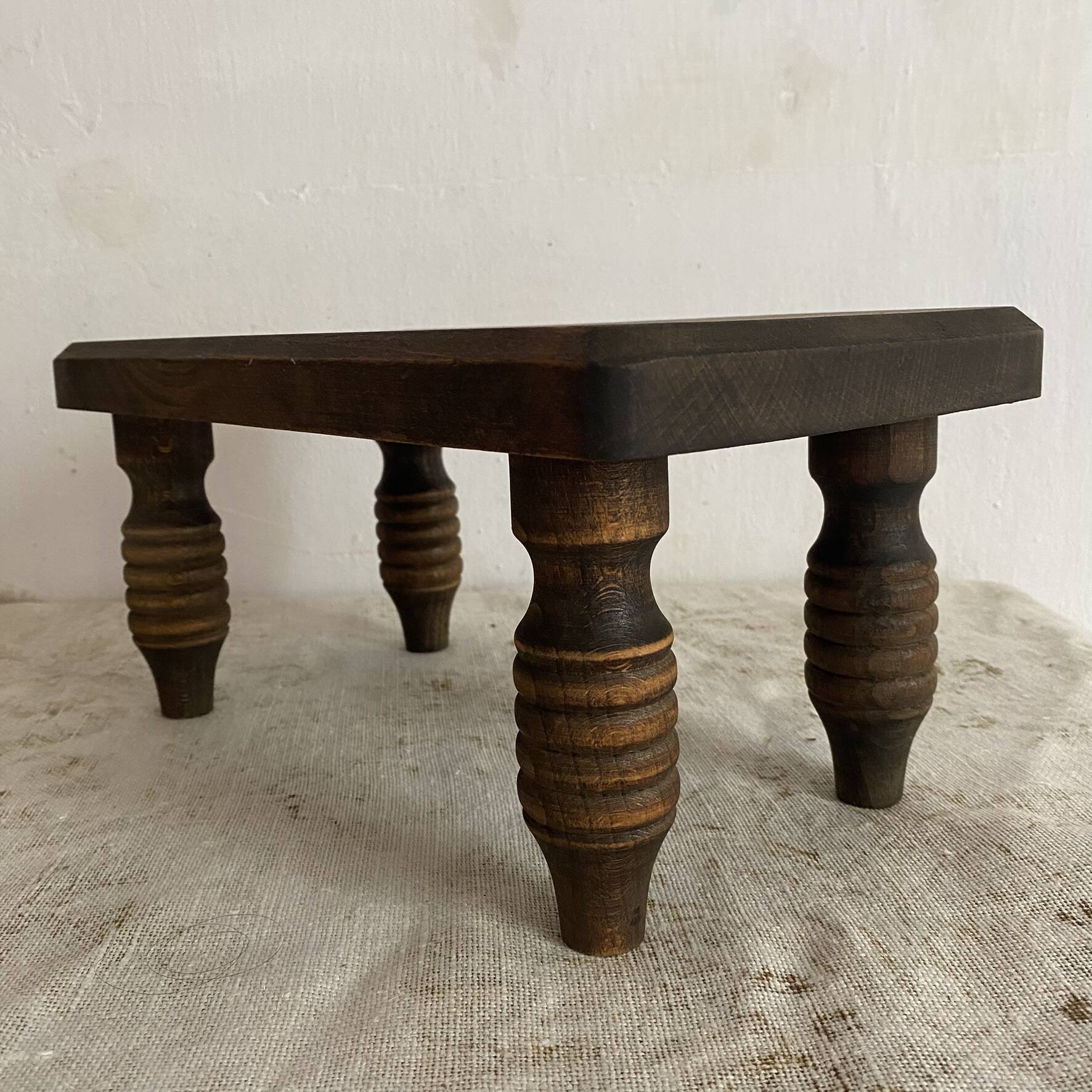 Low stool, turned wooden legs.