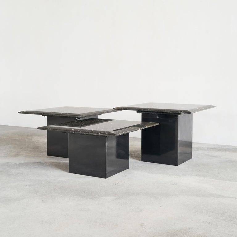 Set of 3 marble and lacquer coffee tables, 1970s.
