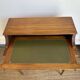 Louis XVI style mahogany telephone table with a green leather top.