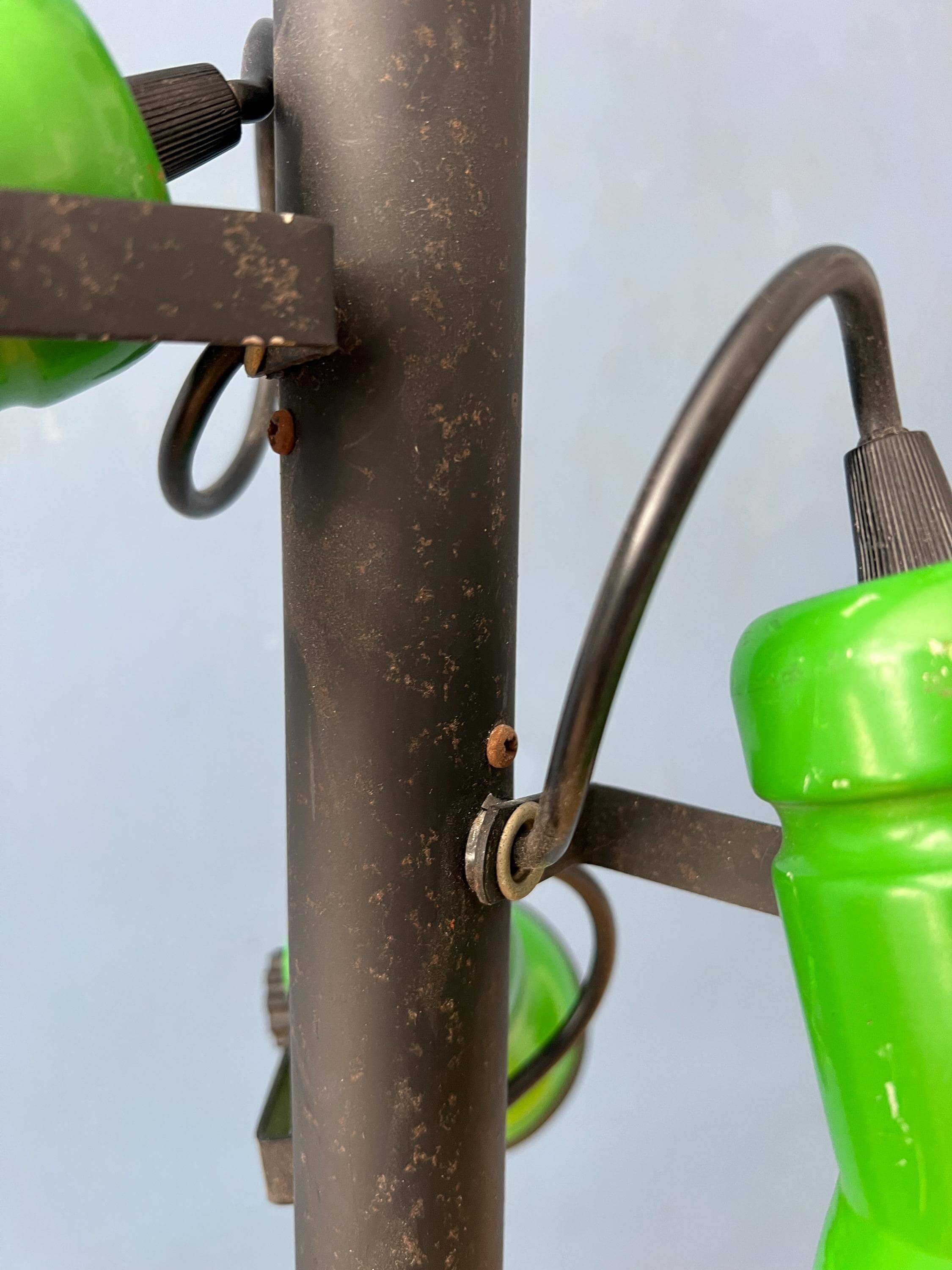 Vintage pendant light with three green spots.