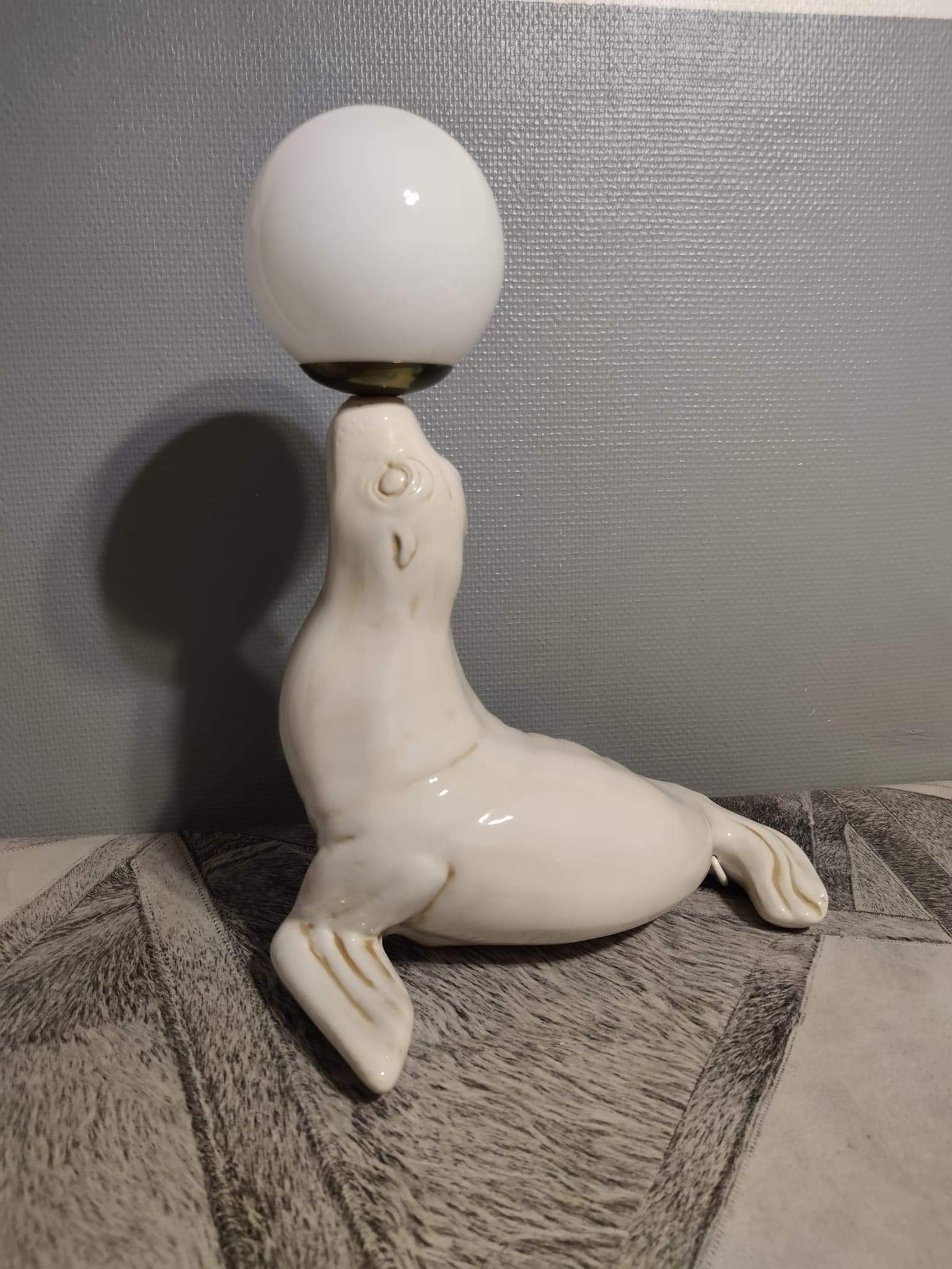 White ceramic sea lion lamp and opaline globe
