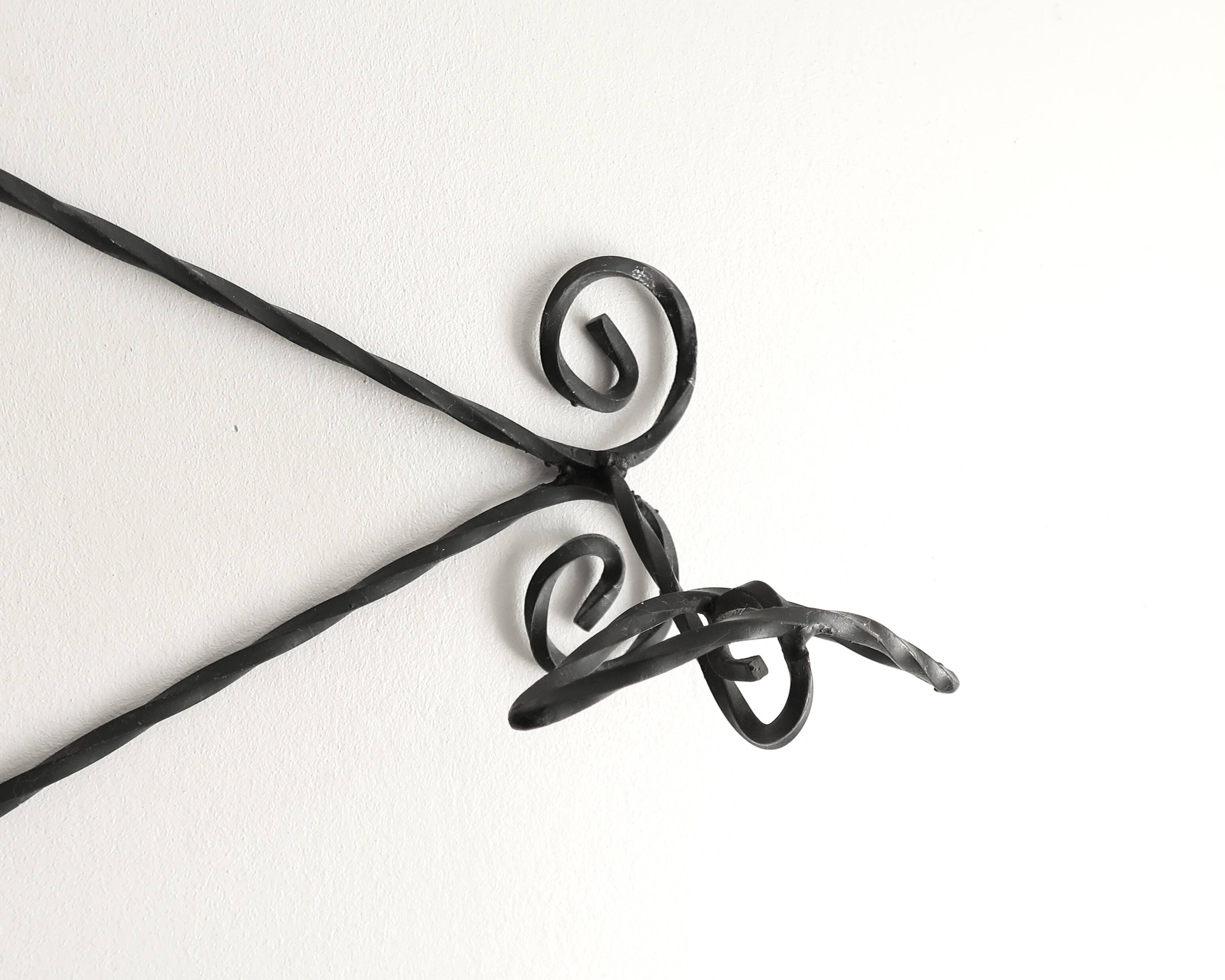 Twisted wrought iron wall coat rack with three hooks