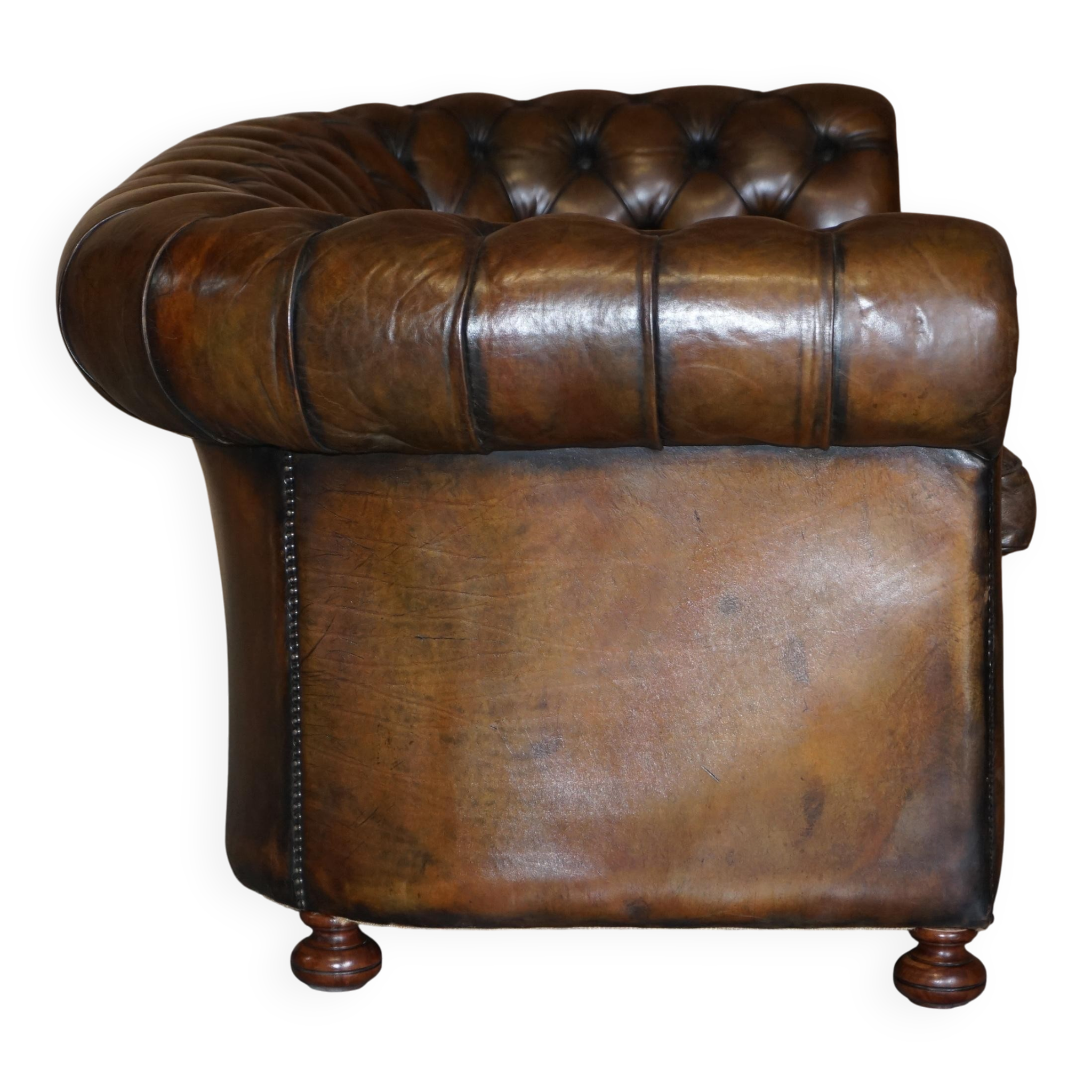 Restored leather Chesterfield sofa, walnut legs.