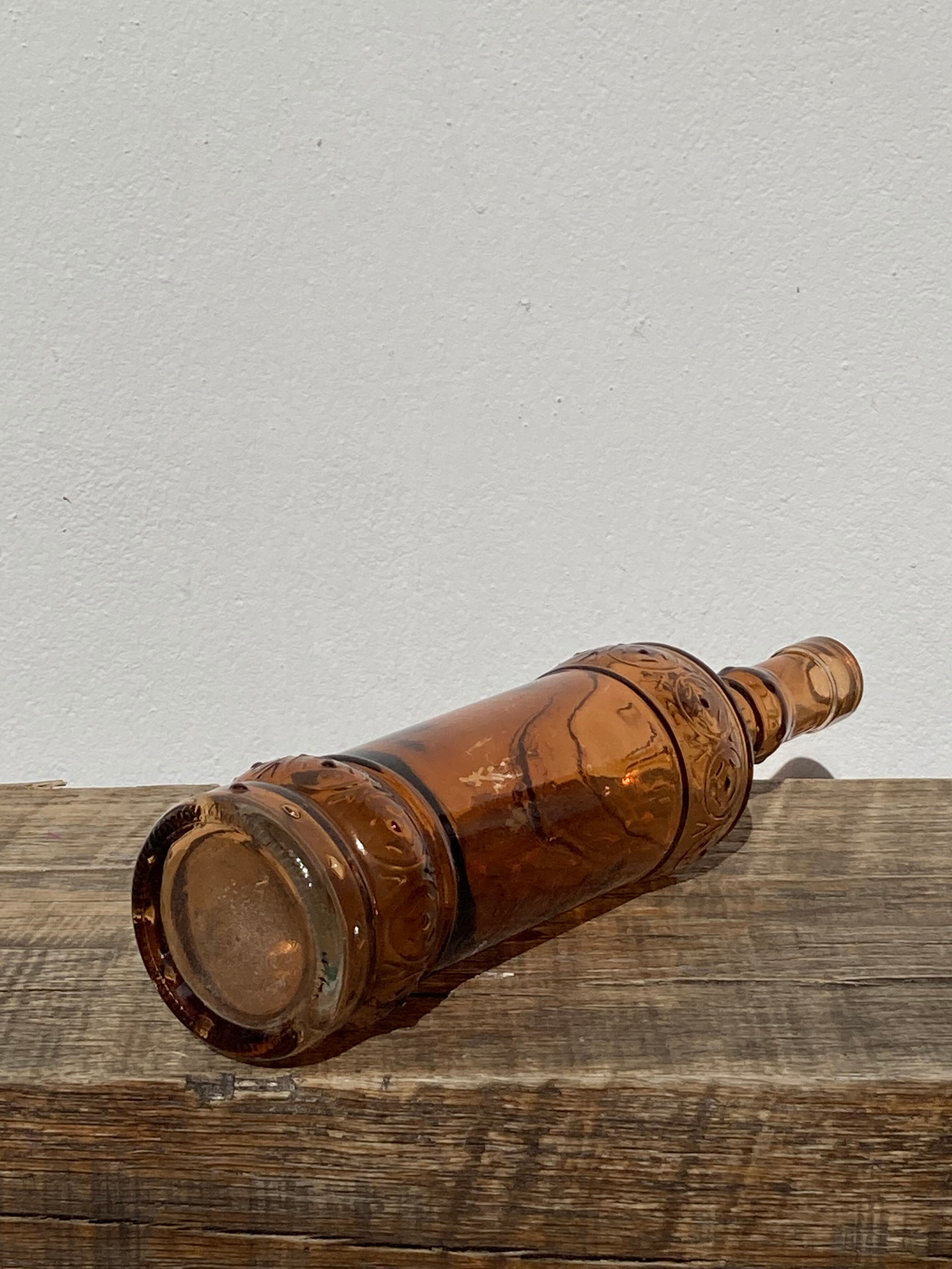 Vintage amber bottle in patterned brown glass