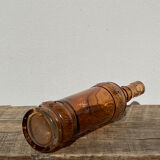 Vintage amber bottle in patterned brown glass