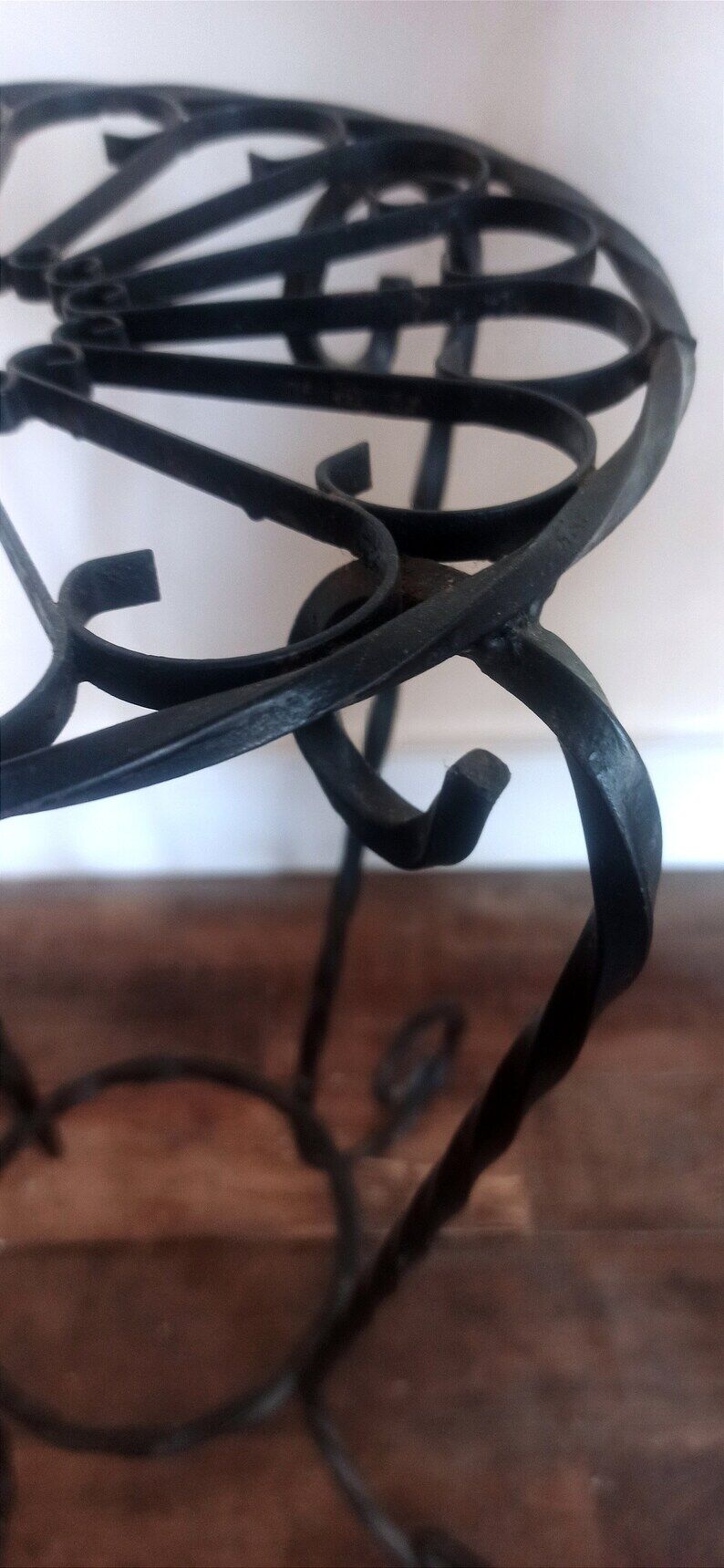 Black wrought iron support for plants