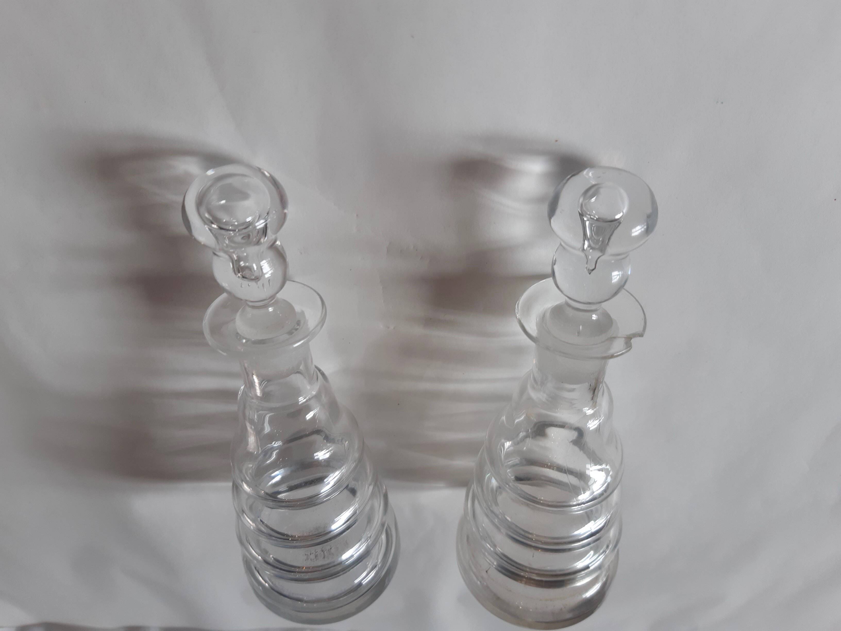 Set of two oil and vinegar glass cruets.