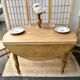Round oak table with a drop leaf.