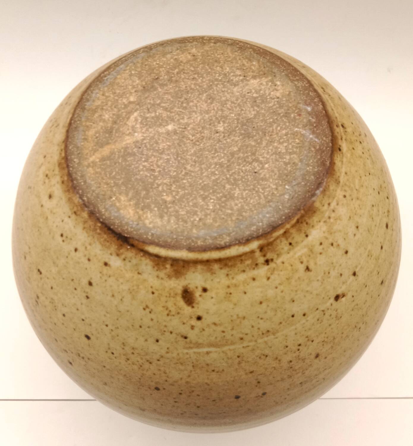 Vintage speckled brown stoneware jug in a round shape.