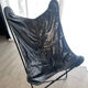 Fauteuil papillon en similicuir en parfait état