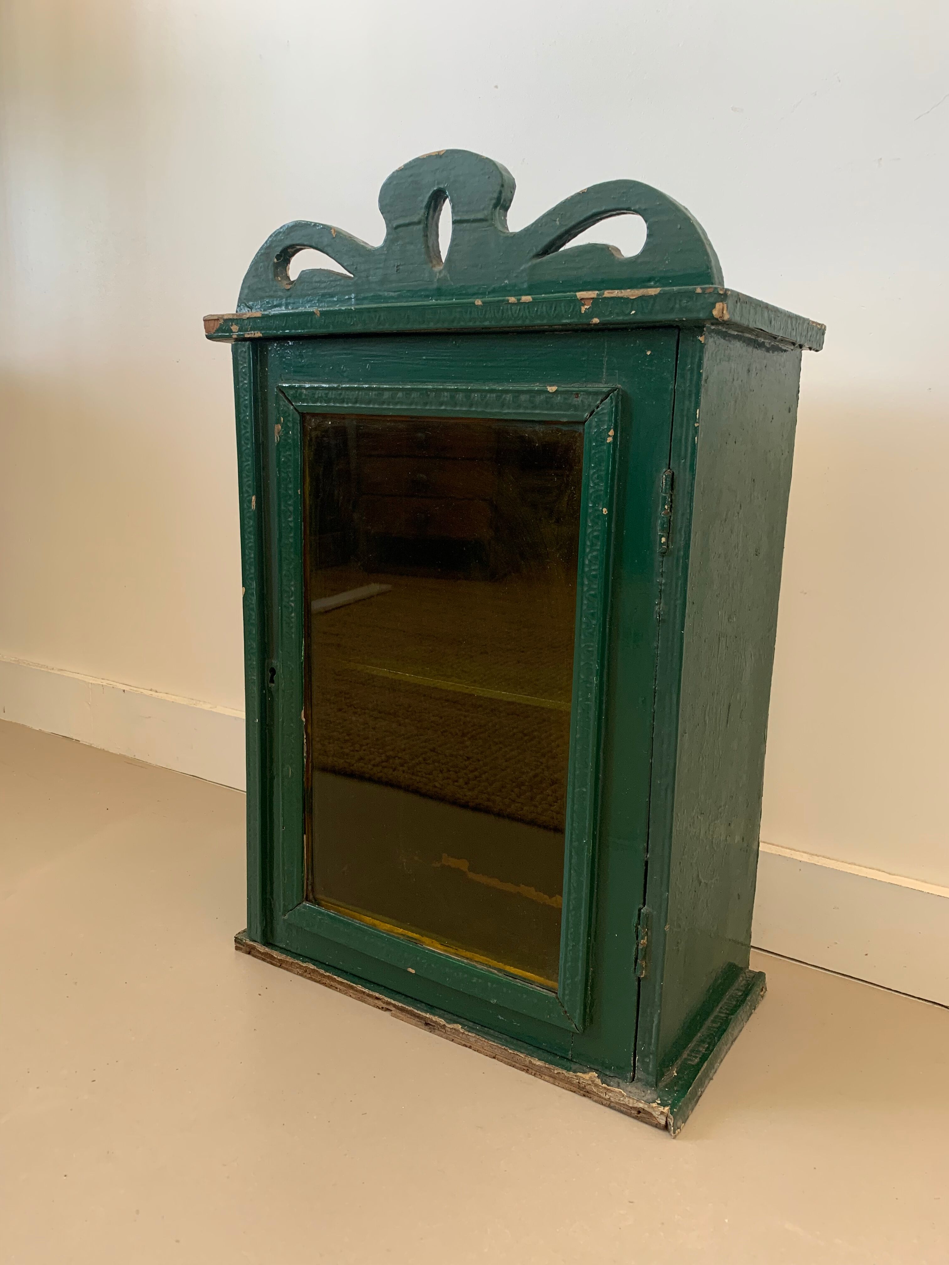 Wall vitrin with pediment