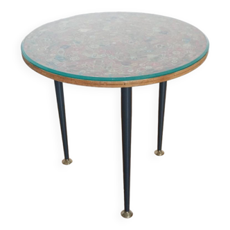 Small side table decorated with cigar rings under beveled glass