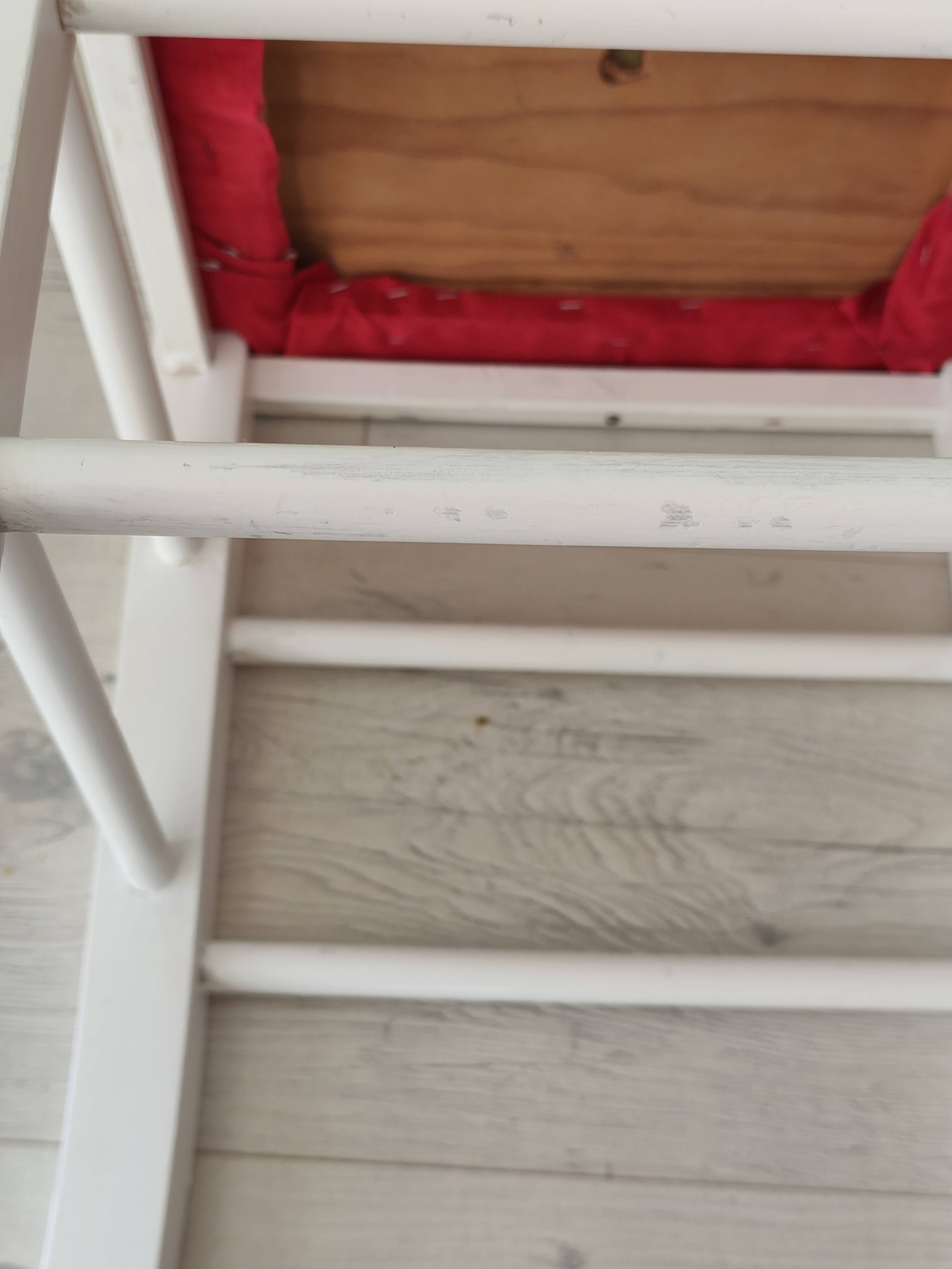White pine stool with a red seat.