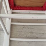 White pine stool with a red seat.