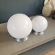 Pair of ceiling lights or wall lights with white glass globes.