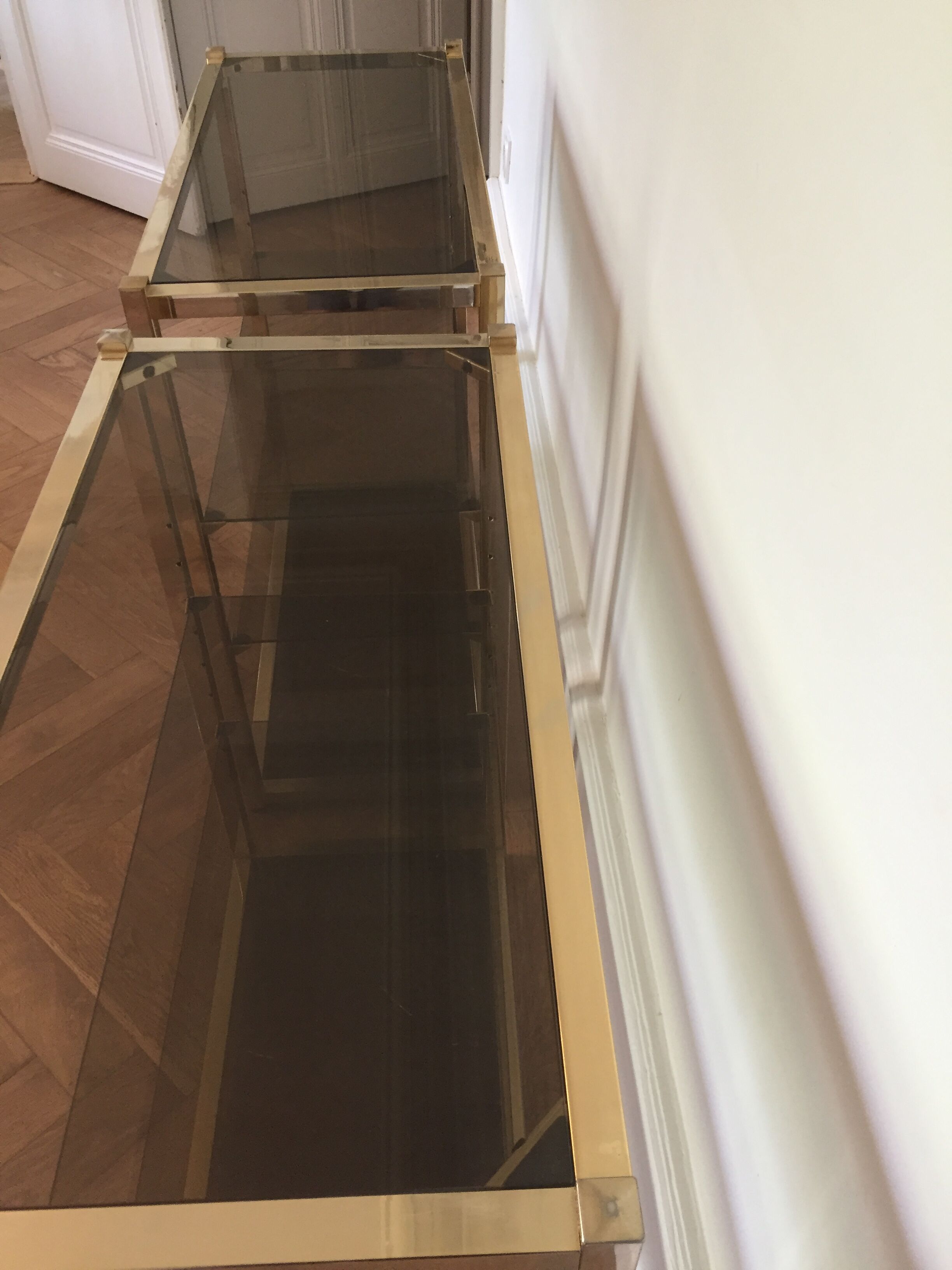 Pair of consoles brass shelves and smoked glass design Roche Bobois