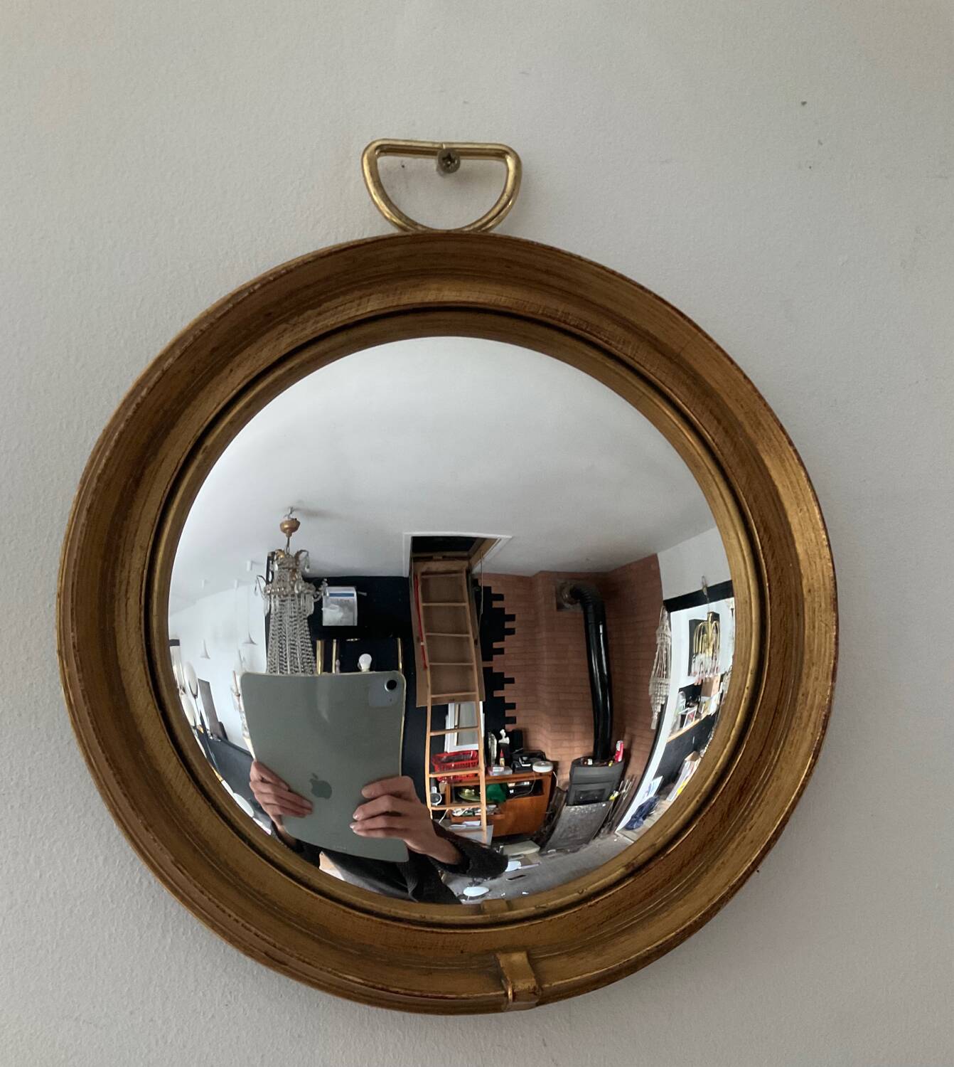 Vintage witch's eye mirror in gilded wood
