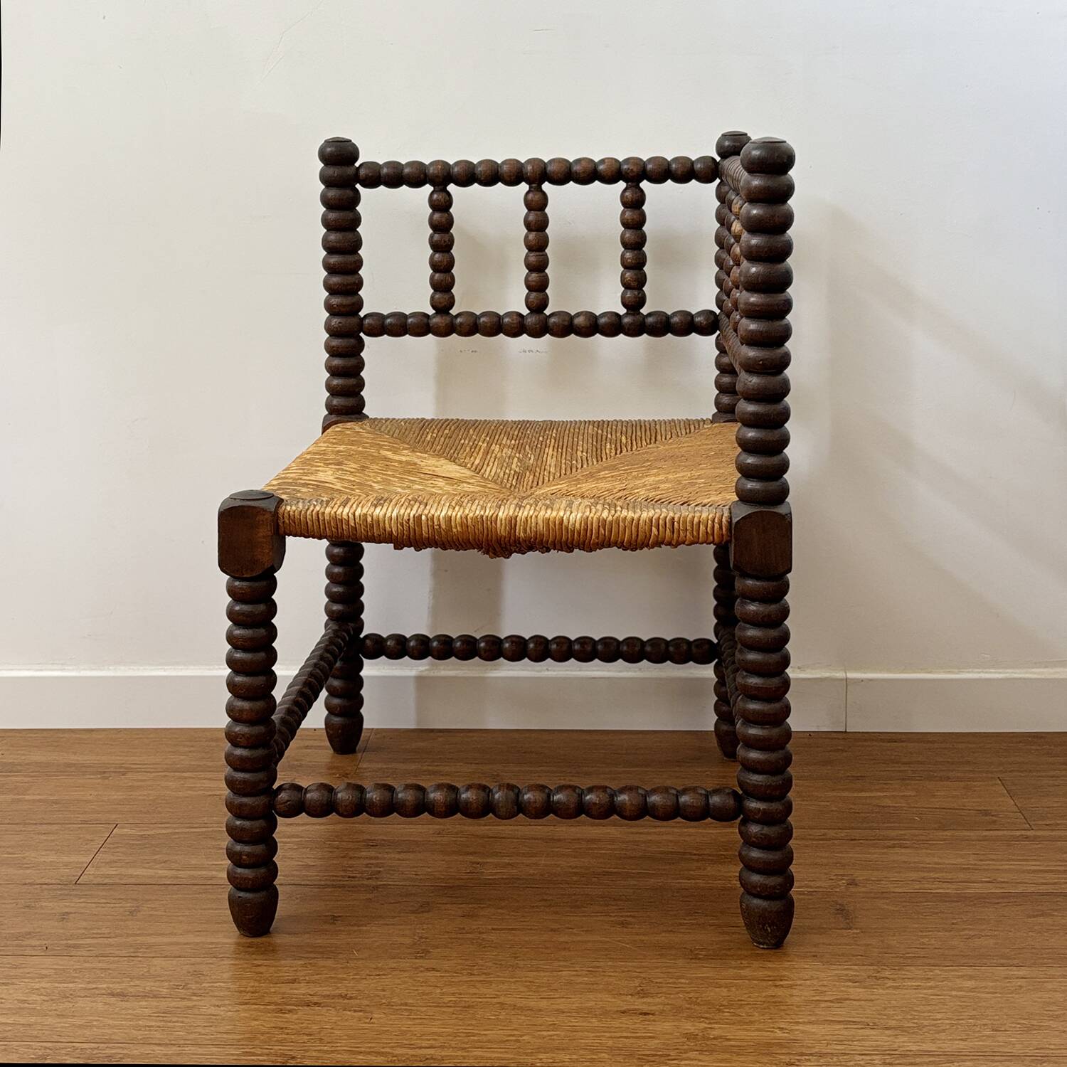 Turned wood corner chair with straw seat