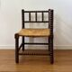 Turned wood corner chair with straw seat