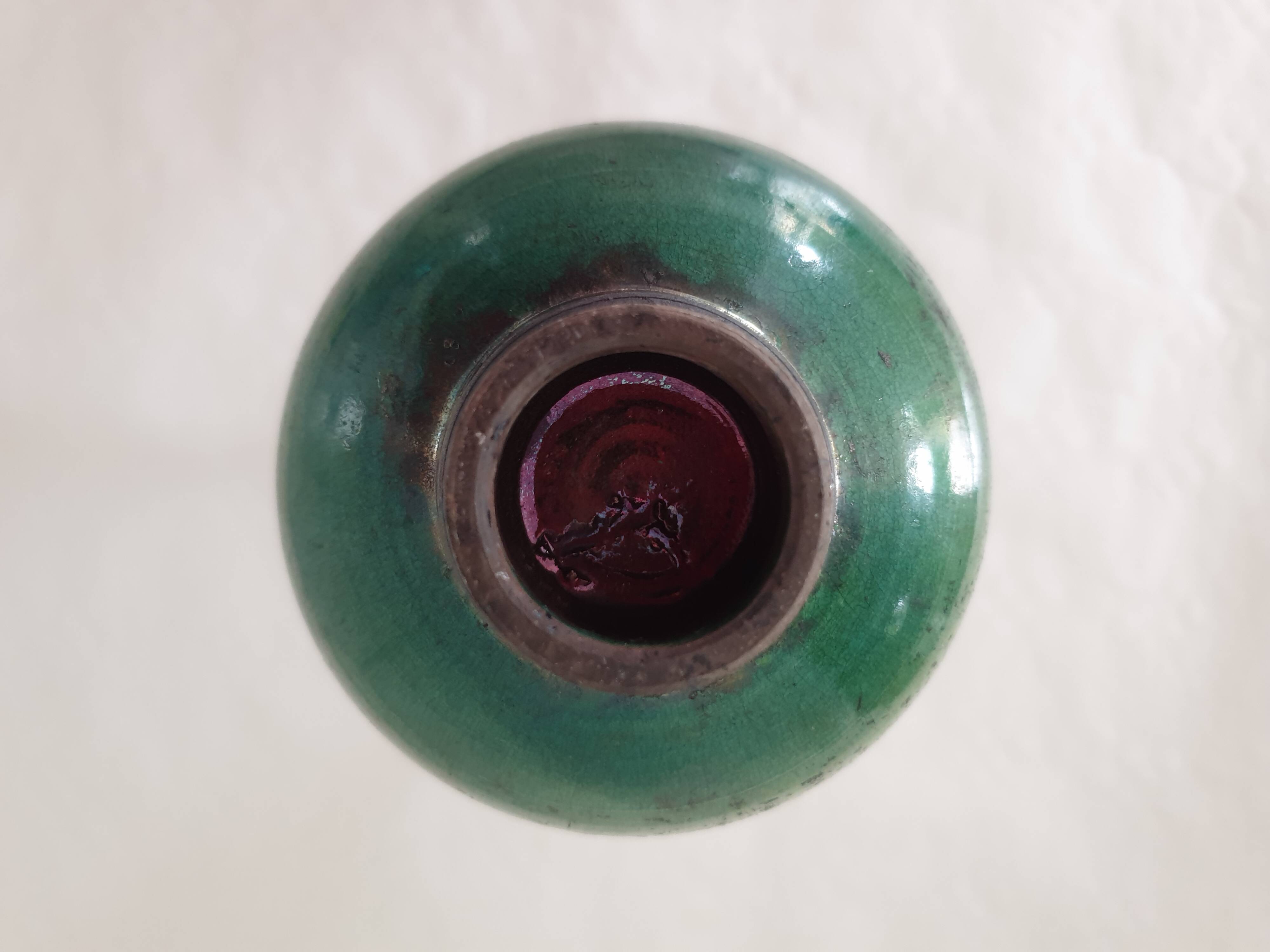 Green pot-bellied ceramic vase with foot and high, narrow neck in signed raku