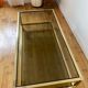 Gold metal coffee table and smoked glass