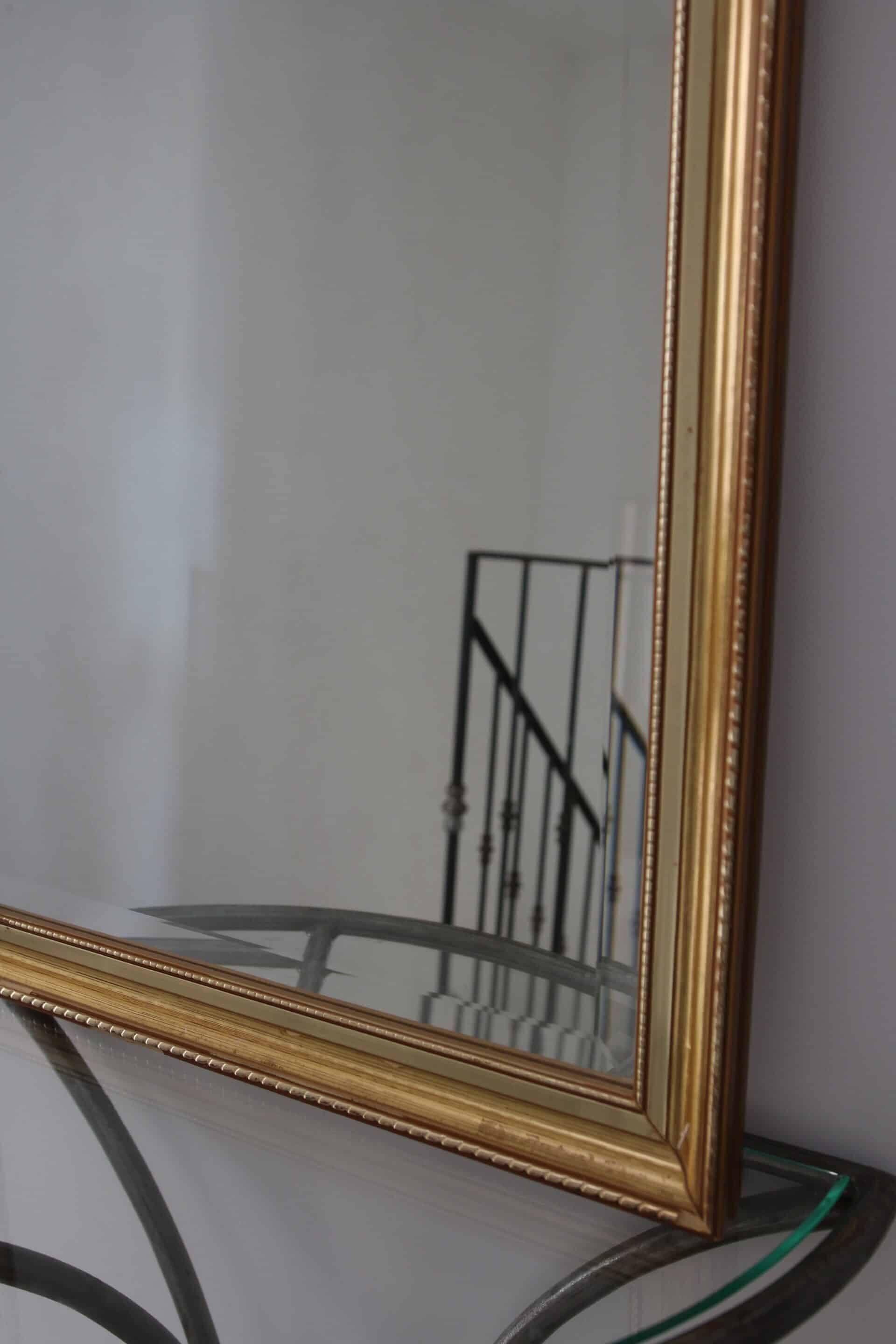 Large beveled mirror in carved wood